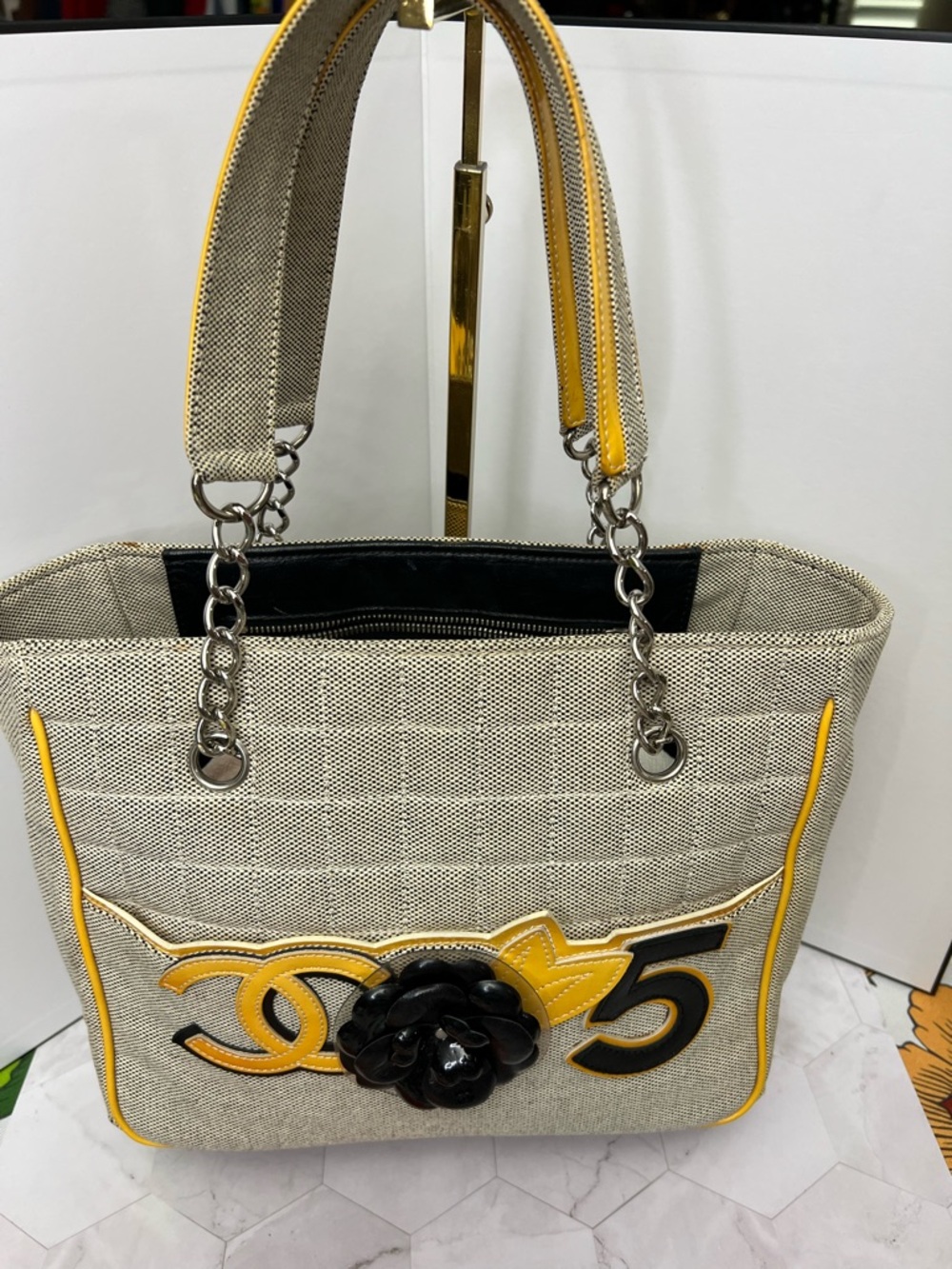 CHANEL Beige Tote with Yellow Trim and Black Camellia Accent
